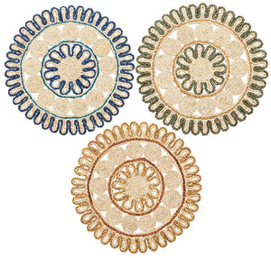 Three round, handwoven coasters by Kim Seybert feature intricate looped patterns in green corn husk, outlined in blue, green, and tan—artfully arranged to reflect the Casbah Placemat’s artisanal style.