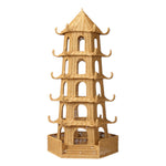 The Bardot Pagoda in Light Honey Rattan, Large by Made Goods is a tall, multi-tiered structure with arched openings and decorative curved roof edges, crafted from woven wicker in a pagoda shape.