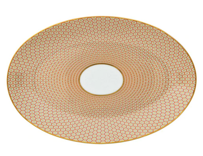 The Tresor Orange Medium Oval Plate Pattern #3 by Raynaud features a white center with gold and red hexagonal motifs, highlighting poetic porcelain artistry in its hand-painted details.