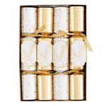 The Caspari Cheers To You Crackers box includes six festive crackers in gold and white—three with "Cheers" and three with polka dots—each tied with a gold ribbon and filled with hidden toy surprises.
