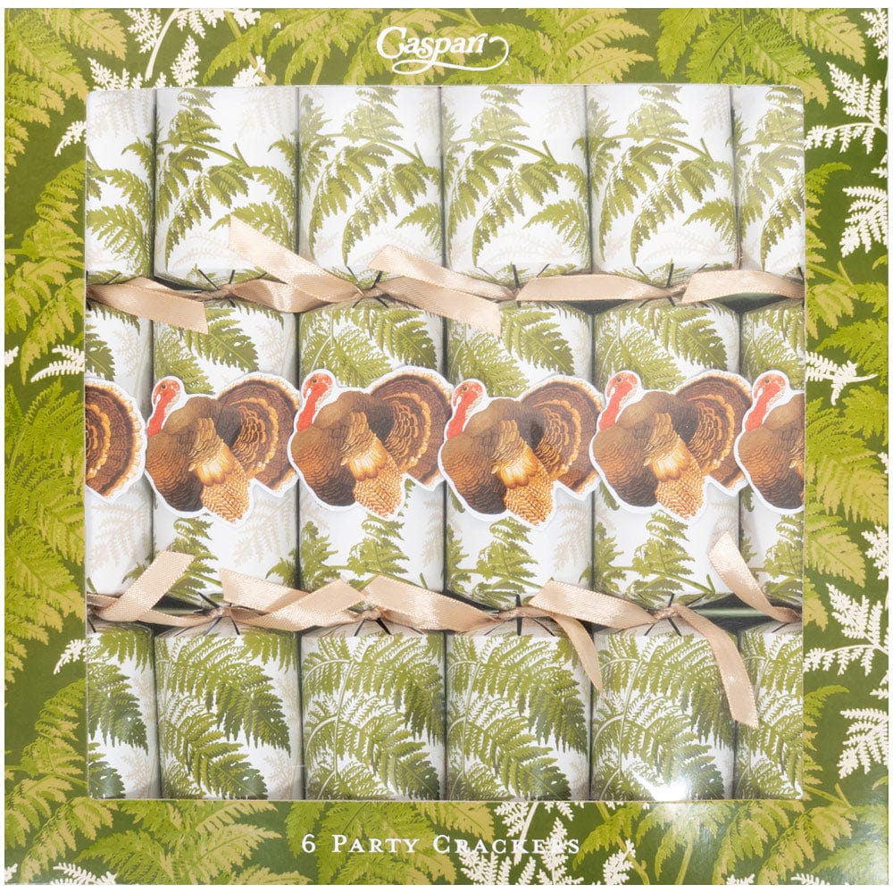The Caspari Turkey Among Ferns Partyware Collection includes a box of six crackers featuring green fern designs and turkey illustrations, tied with beige ribbons—perfect for enhancing your Thanksgiving or autumn table setting.