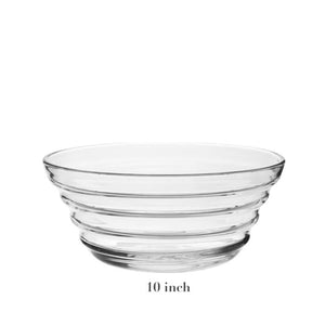 The Ripples Serveware Collection bowl by William Yeoward Crystal features three horizontal ridges, an artisanal touch, and is handmade in crystal glass. This clear 10-inch diameter piece is shown on a white background.