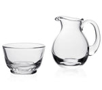 The William Yeoward Crystal Classic Sugar & Cream Set features an elegant clear glass bowl and handled pitcher, both empty and side by side on a white background—perfect for your breakfast table.