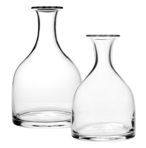 Two clear, wide-bottomed glass carafes from the Classic Carafe Collection by William Yeoward Crystal are displayed side by side on a white background.