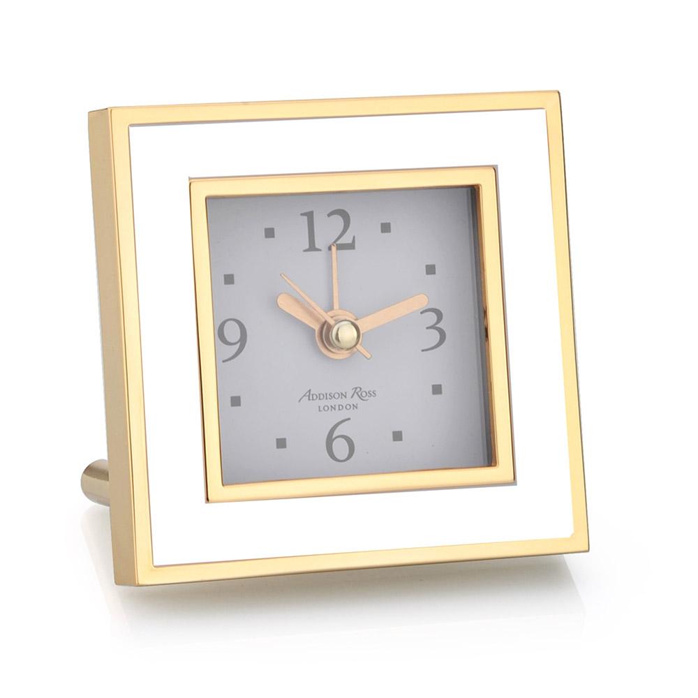 The Addison Ross Gold Square Alarm Clock from the Addison Ross collection features a gold frame, luxury velvet back, white face showing 10:08, silent sweep movement, stand, and simple hour markers—perfect for adding sophistication to any space.