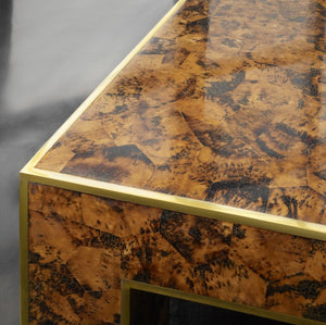 Close-up of the Brice Cocktail Table by Modern History, showcasing its glossy faux roffee Penshell veneer surface and elegant brass edge detailing.