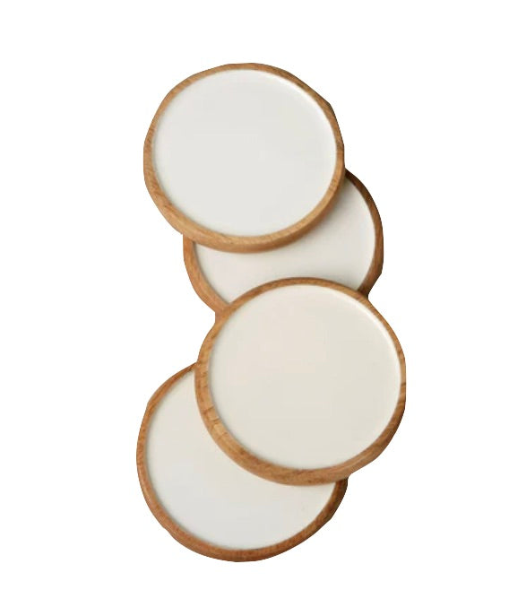 The Be Home Madras Curva Round Coaster Set features four white ceramic coasters with handcrafted Madras Mango Wood rims, shown stacked in a staggered arrangement on a white background.