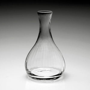 The William Yeoward Crystal Corinne Wine Carafe features a wide base and narrow neck, crafted from handmade crystal glass, shown clear and empty against a neutral gradient background.