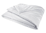 The Yves Delorme Mandarin Silk Comforter, featuring a smooth, quilted surface, is displayed against a plain white background.