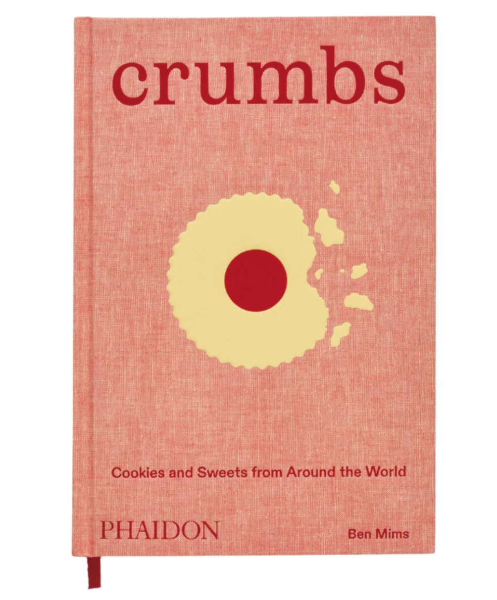 Phaidon's "Crumbs: Cookies and Sweets from Around the World" by Ben Mims is a delightful baking book with international recipes, featuring a cover design with a bitten cookie graphic.