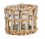 The Provence Rattan Tealight by Juliska features a clear glass votive holder encased in a natural-finish woven rattan basket, perfect as a charming accent, shown against a white background.