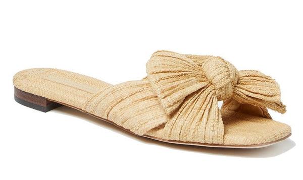 A Loeffler Randall Daphne Pleated Bow Slide sandal in tan with a large bow on the top, made from vegan-friendly materials, isolated on a white background.