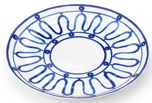 White ceramic plate from Themis Z's Kyma Blue Dinnerware Collection, featuring symmetrical blue looped and circular designs around the rim and center, inspired by the Greek Aegean Sea.