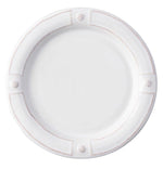 A round white ceramic plate from Juliska’s Berry & Thread French Panel Dinnerware Collection, featuring a raised rim inspired by Parisian architecture with four textured accents evenly spaced around the edge.