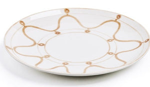 Part of Themis Z's Serenity Beige Dinnerware Collection, this handcrafted white ceramic dinner plate features a tan wavy line and dot motif along the rim, shown in a slightly angled photograph.
