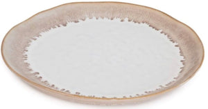 The Burlington Bluff Dinnerware Collection by Simon Pearce features a round ceramic plate with a white center, light brown rim, and an irregular edge inspired by pinch-pot designs where the two colors meet.