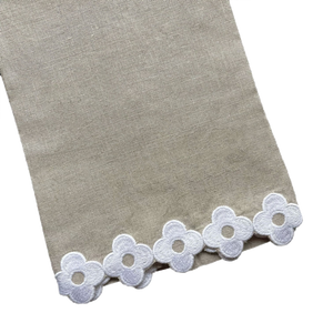 Dolly Tip Towel, Flax 100% linen fabric with a decorative border of white lace flowers, displayed on a black background by Haute Home.