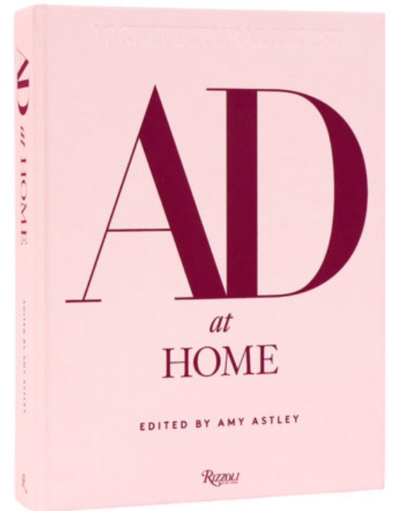 AD at Home: Architectural Digest" is a pink hardcover book by Rizzoli, celebrating creative homes and expert interior design.