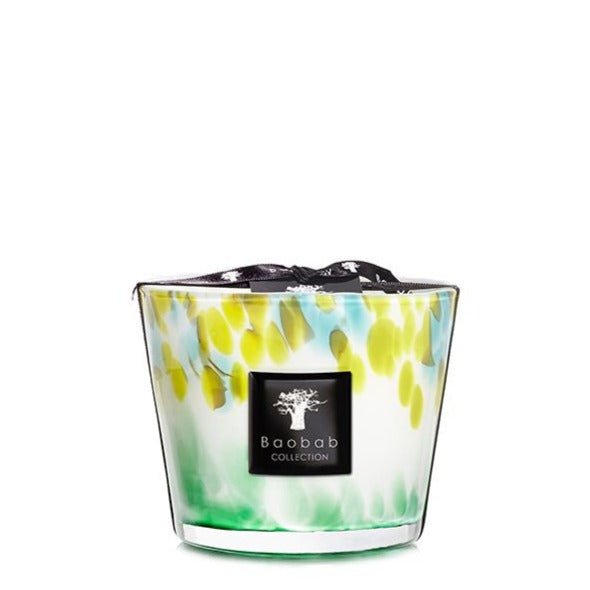 A Baobab Collection Eden Forest candle in a decorative glass container with yellow and green splatter pattern.