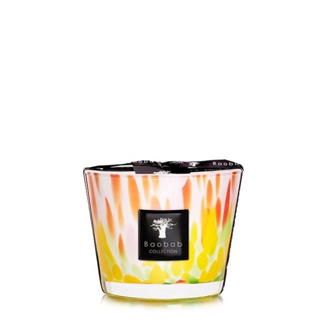 A colorful Baobab Collection Eden Garden candle with a flame-like design on the glass container, set against a plain white background.