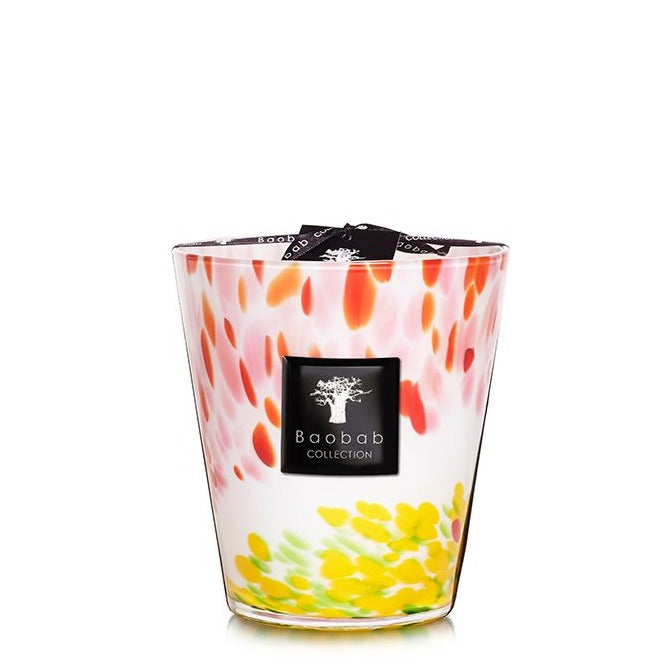 A luxurious Baobab Collection Eden Garden candle in a multicolored glass jar with a pink, white, and yellow teardrop pattern.