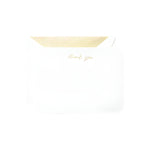 The Crane Gold Thank You Round Corner Card Set features white envelopes with gold-striped interiors and "thank you" in metallic gold foil on the front—an elegant way to express your gratitude.