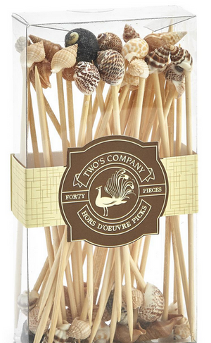 The "Sea Fare 40 Shell Hors D'oeuvre Long Picks" by Two's Company come in a clear box, featuring forty wooden picks topped with seashell accents, perfect for parties and made from sustainable materials.