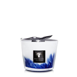 A Baobab Feathers Touareg Collection candle with a white and blue design, displayed against a plain background, tied with a silver bow, infused with Feathers Touareg scent.