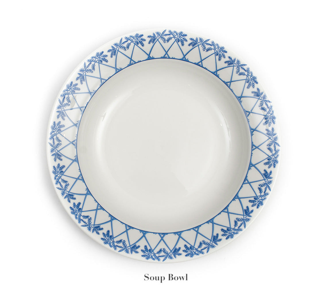 A Fine Bone China soup bowl from the Azure Blue Dinnerware Collection by Pink House Mustique, featuring a blue geometric and floral rim pattern, custom made and photographed from above on a white background.