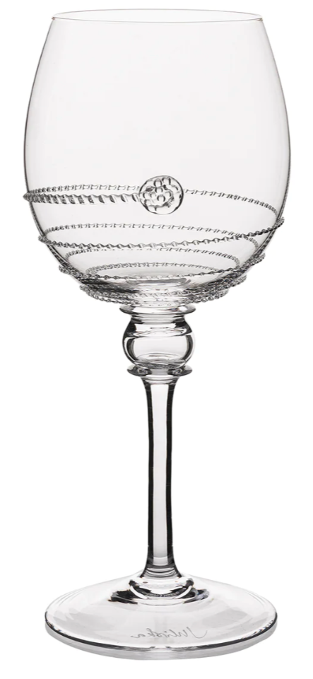 The Amalia Drinkware Collection by Juliska features clear wine glasses with intricate silver wire details and a round silver accent, highlighting the artistry behind each piece.