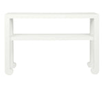 The Askel Console by Made Goods is a white rectangular table with a lower shelf, gently curved legs, and faux raffia detailing, shown against a plain white background.