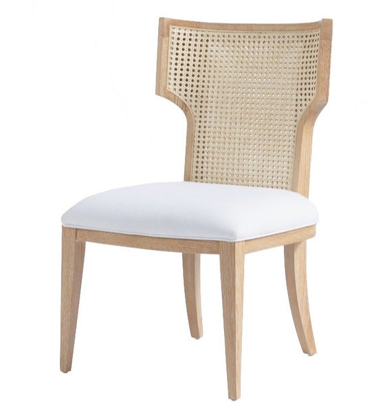 Made Goods Carleen Dining Chair with a white cushioned seat and cane backrest.