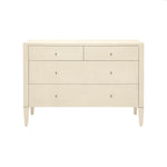 The Conrad Dresser Collection by Made Goods features a beige, rectangular dresser with four faux raffia wood drawers, small round knobs, and tapered legs, shown against a white background.
