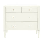 A white four-drawer dresser from the Conrad Dresser Collection by Made Goods features wood construction, two small top drawers, two large bottom drawers, simple round knobs, and tapered legs.