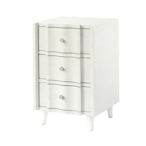 The Made Goods Essery Nightstand features three drawers, subtle vertical and horizontal lines, round knobs, tapered legs, and faux raffia details for a refined transitional look.