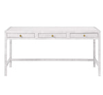The Isla Desk by Made Goods is a rectangular white desk with three front drawers, each with a small round gold knob, and simple straight legs.
