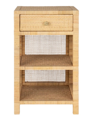 The Isla Nightstand Collection by Made Goods features a sturdy rectangular rattan frame, one soft-close top drawer, two open shelves below, and a woven design on all sides.