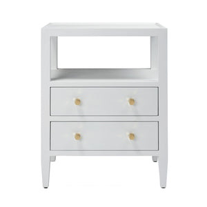 The Jarin Nightstand Collection by Made Goods features a white wooden nightstand with an open shelf, two drawers with gold knobs, and four legs. Smooth European glides ensure effortless drawer access, combining quality craftsmanship and style.