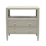 The Jarin Nightstand Collection by Made Goods features a light gray linen finish, two drawers with gold round knobs, European glides, an open shelf above the drawers, and four tapered legs.