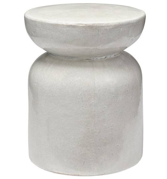 A Made Goods Loxias stool with an hourglass shape and a smooth, light gray finish.