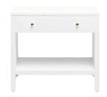 The Maris Nightstand Collection by Made Goods features a white wooden side table with raised feet, two gold knobs, an overlay drawer panel, and an open lower shelf, set against a plain white background.