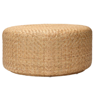 The Moselle Coffee Table by Made Goods is a round, drum-shaped piece featuring a woven rattan herringbone pattern, displayed against a white background.