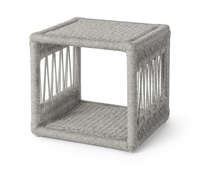 The Mara Outdoor Chaise Side Table by PALECEK features a square, open-sided design with a gray synthetic rope weave, aluminum frame, and solid surfaces on top and bottom—ideal for modern outdoor furniture settings.