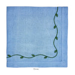 The Garden Vine Napkin Set by Deborah Rhodes features light blue Italian linen with green vine and leaf embroidery, labeled "Ocean" below—perfect for elevating your table setting.