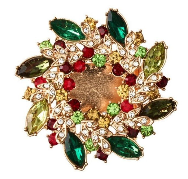 The Gem Wreath Napkin Ring Set by Kim Seybert features circular gold napkin rings adorned with green, red, yellow, and clear gemstones in a floral design—ideal for adding festive sparkle to your holiday table.