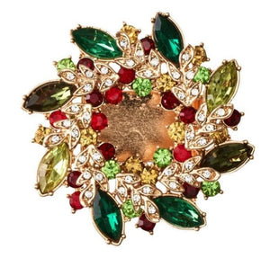 The Gem Wreath Napkin Ring Set by Kim Seybert features circular gold napkin rings adorned with green, red, yellow, and clear gemstones in a floral design—ideal for adding festive sparkle to your holiday table.