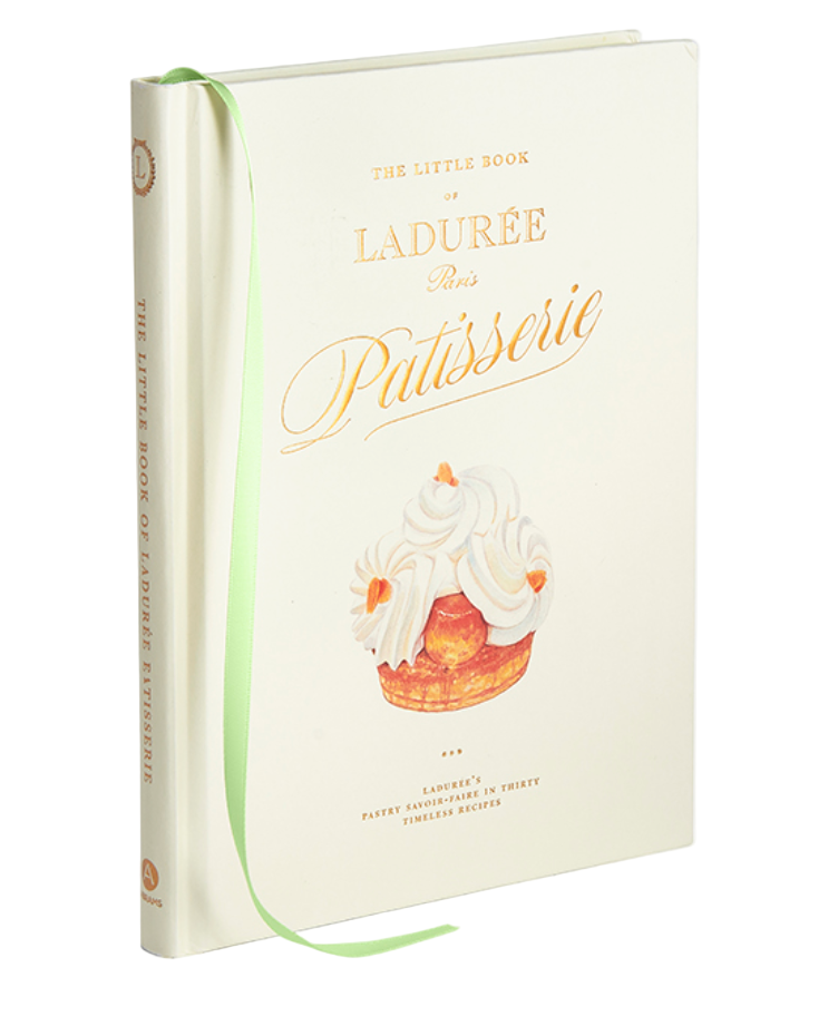 Abrams’ "The Little Book of Ladurée: Patisserie" is a hardcover book featuring pastry illustrations, a green ribbon bookmark, and recipes for classic Parisian desserts.
