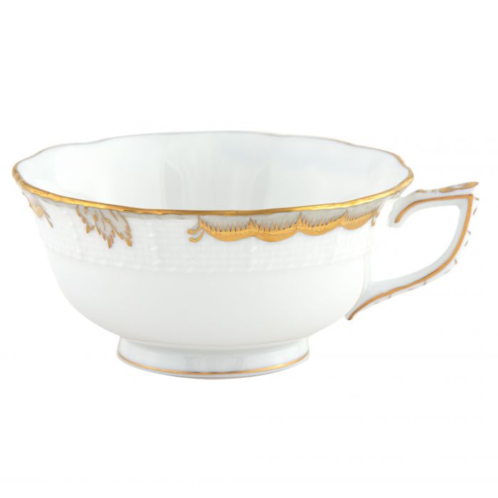 The Herend Princess Victoria Gray Collection teacup by Herend features white porcelain with gold trim, a decorative handle, scalloped edges, embossed pattern, and an elegant border inspired by Queen Victoria’s timeless style.