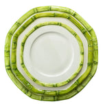 Three plates from the Les Ottomans Green Bamboo Dinnerware Collection, featuring white surfaces and green bamboo-patterned rims, are stacked and viewed from above on a white background.