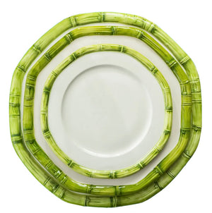 Three plates from the Les Ottomans Green Bamboo Dinnerware Collection, featuring white surfaces and green bamboo-patterned rims, are stacked and viewed from above on a white background.